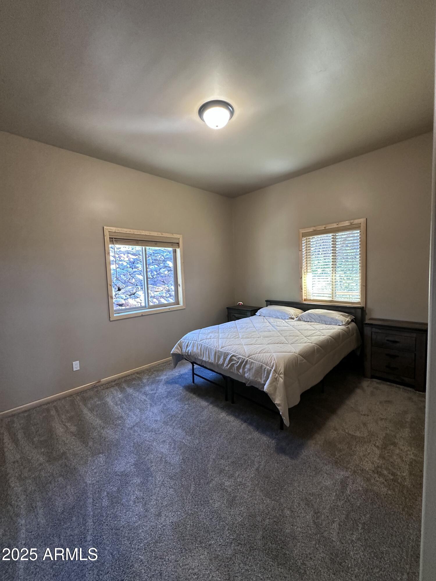 3457 Whispering Pines Road Pine, AZ 85544 - Photo 12 of 27 a spacious bedroom with a bed and a window