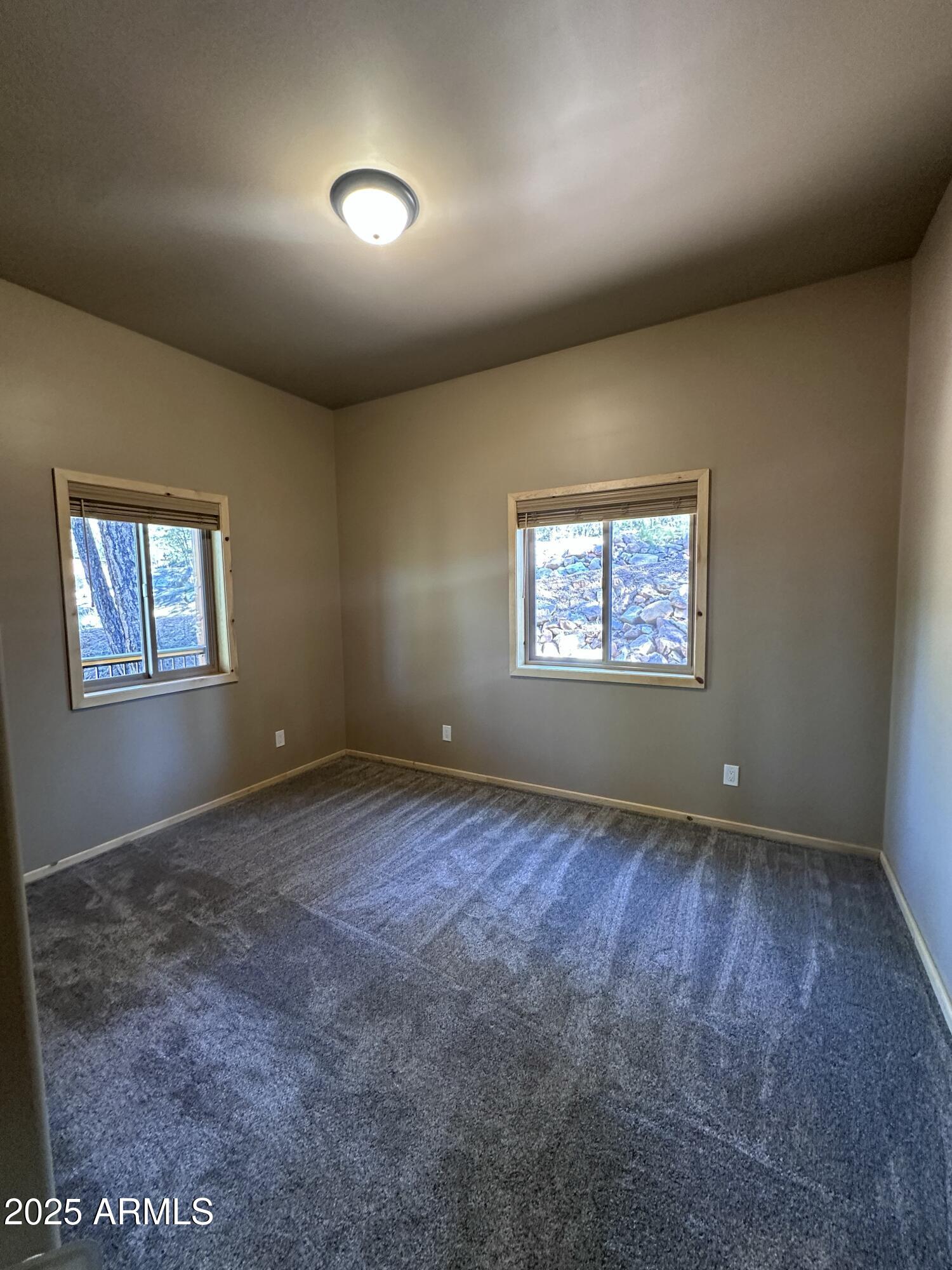 3457 Whispering Pines Road Pine, AZ 85544 - Photo 13 of 27 an empty room with windows