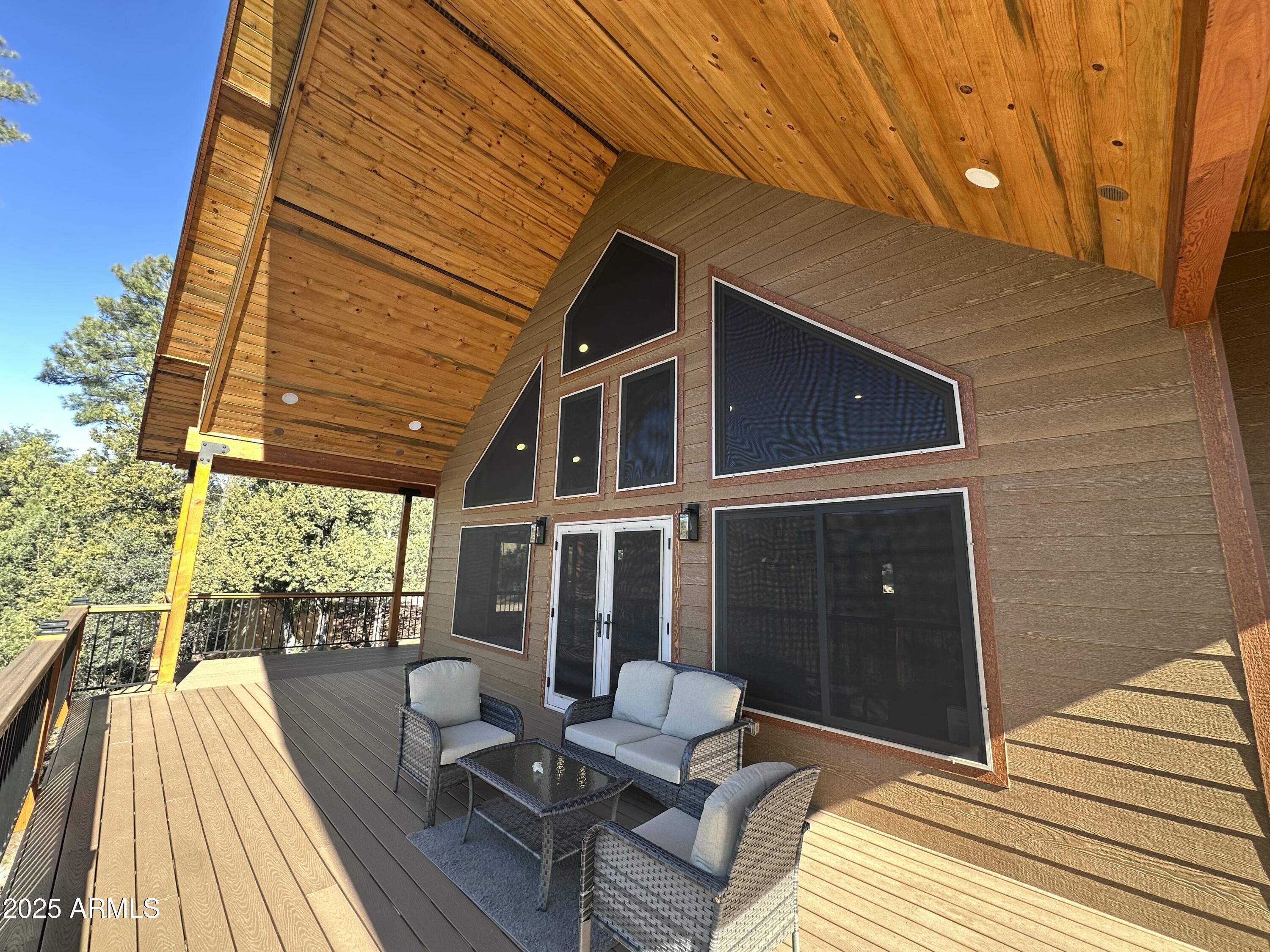 3457 Whispering Pines Road Pine, AZ 85544 - Photo 20 of 27 a balcony with furniture and wooden floor