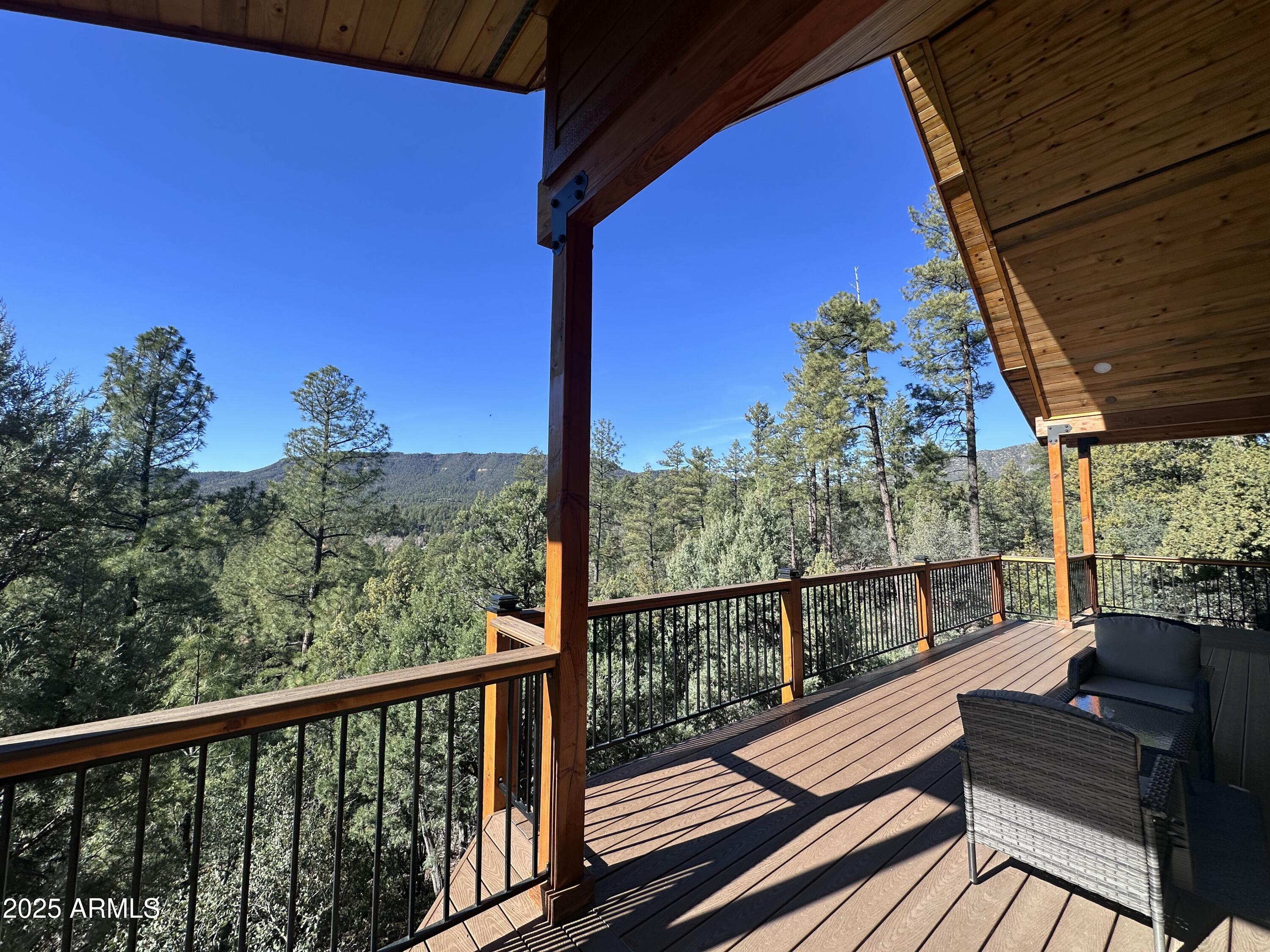 3457 Whispering Pines Road Pine, AZ 85544 - Photo 22 of 27 a view of a balcony with wooden floor and outdoor seating