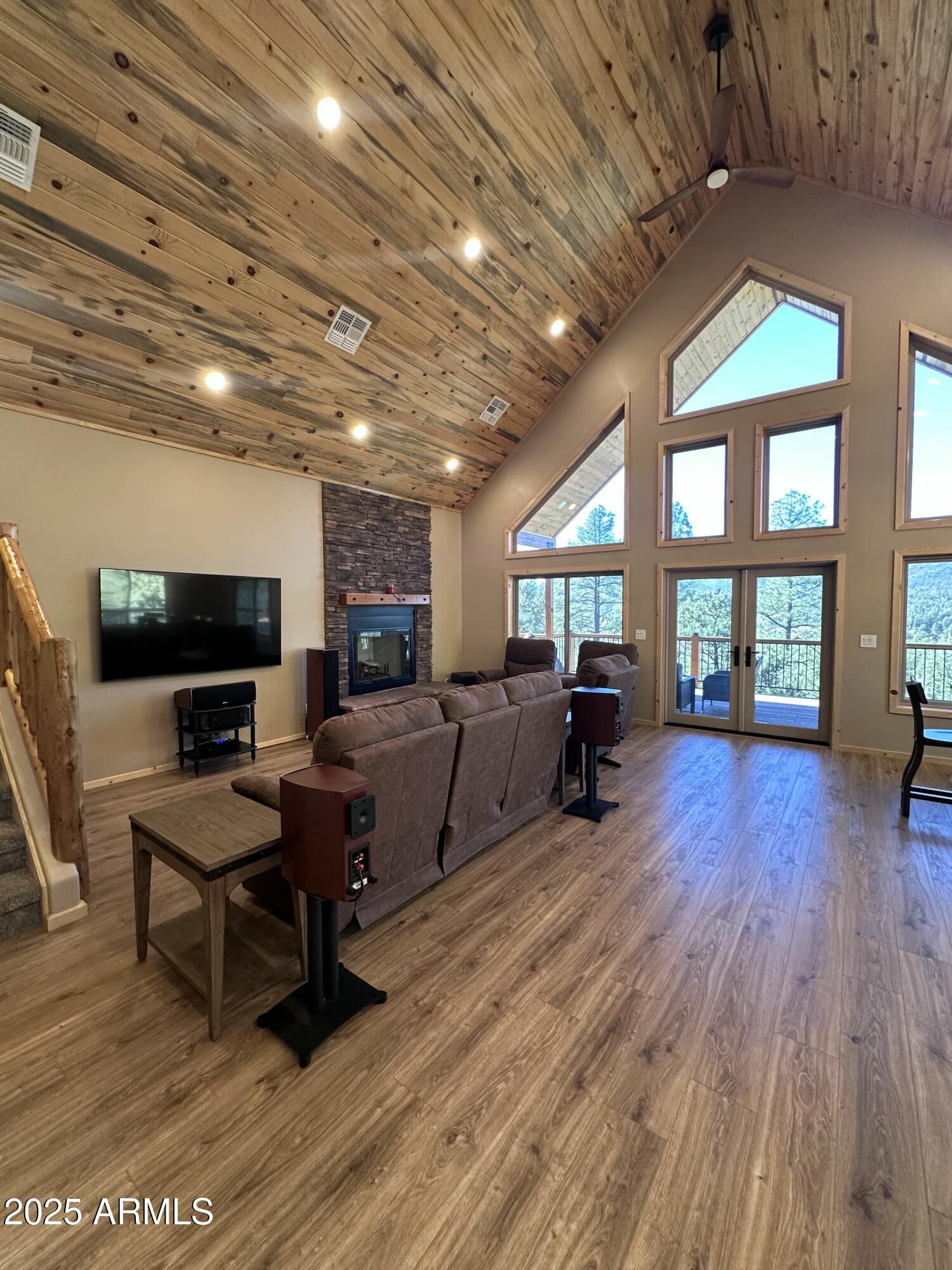 3457 Whispering Pines Road Pine, AZ 85544 - Photo 5 of 27 a living room with furniture a flat screen tv and a fireplace