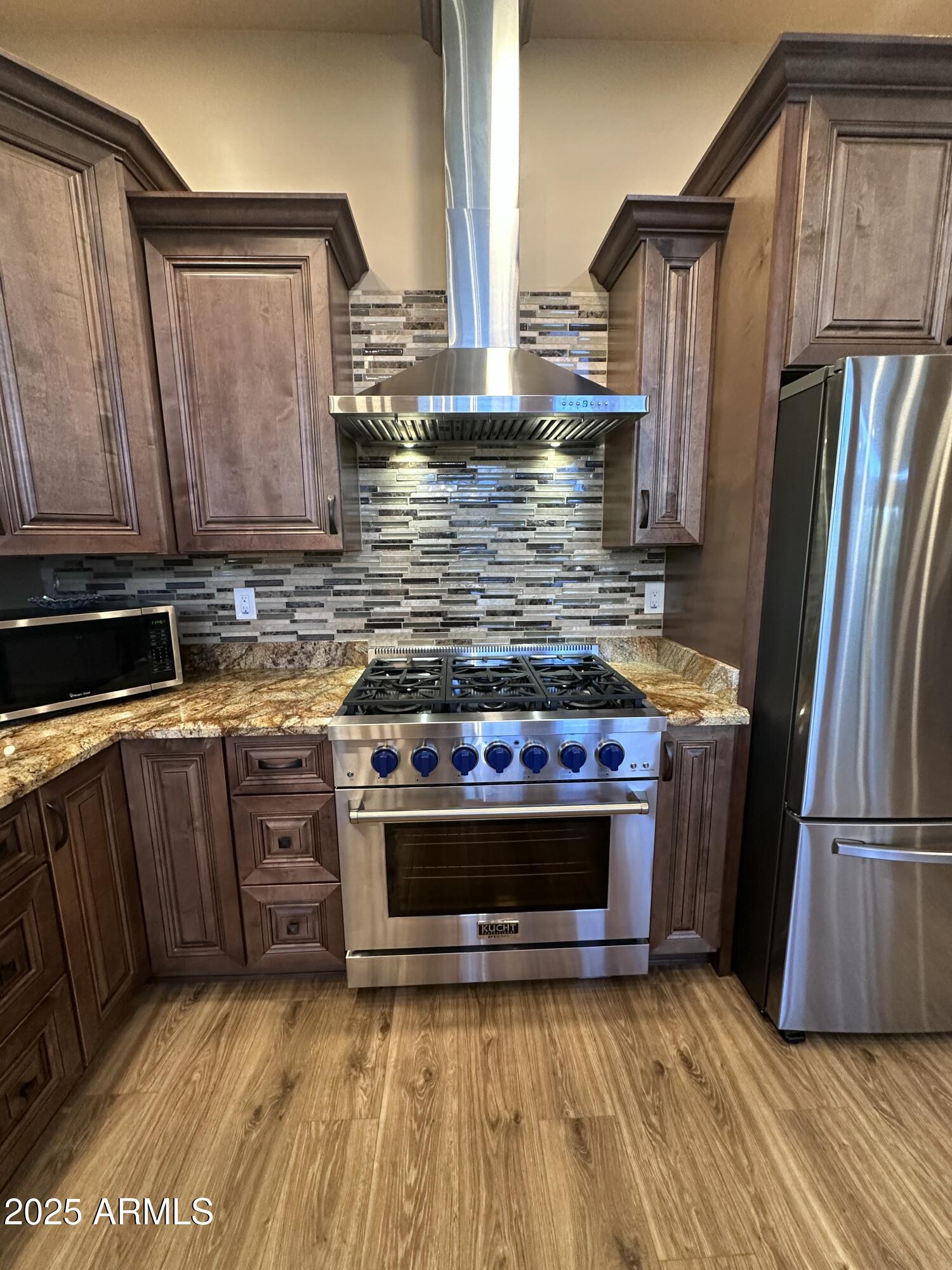 3457 Whispering Pines Road Pine, AZ 85544 - Photo 7 of 27 a kitchen with stainless steel appliances granite countertop a stove a refrigerator and a sink