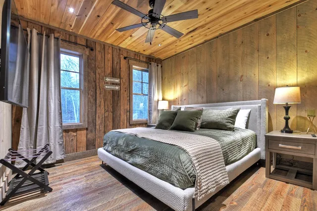 a view of a house with a large window and large tree