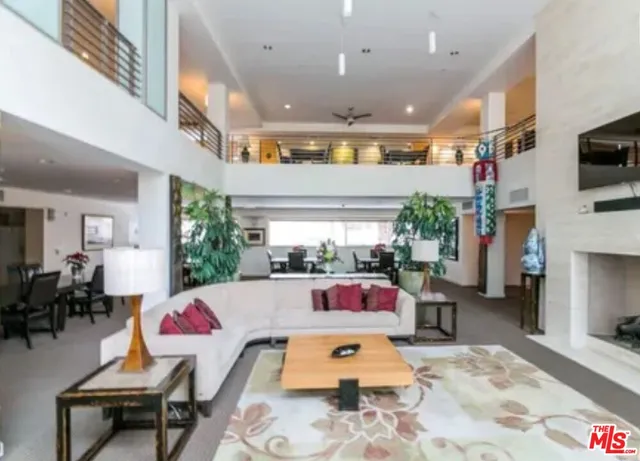 a bedroom with furniture and a large window