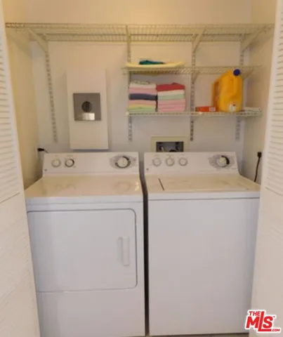 a view of bathroom with a washer and dryer