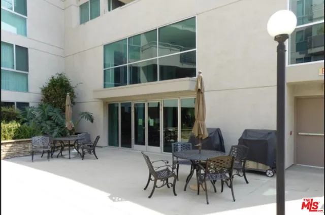 a patio with a table and chairs