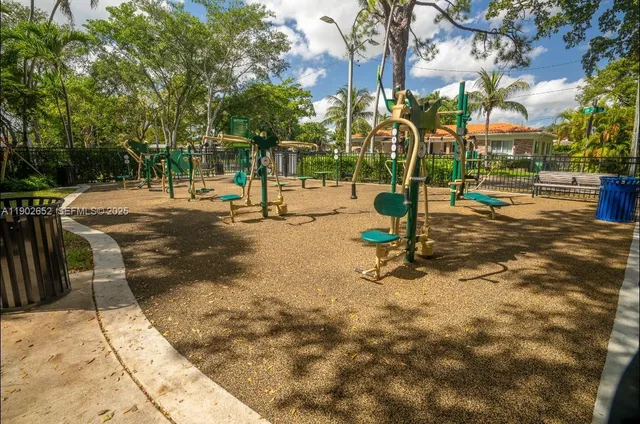 a view of a park with swings and slides