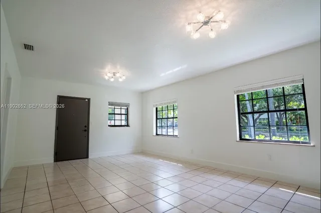 a kitchen with stainless steel appliances granite countertop a sink and a stove next to a window
