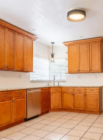 a kitchen with granite countertop a sink and a window