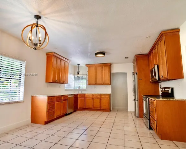 a kitchen with granite countertop a sink and a window
