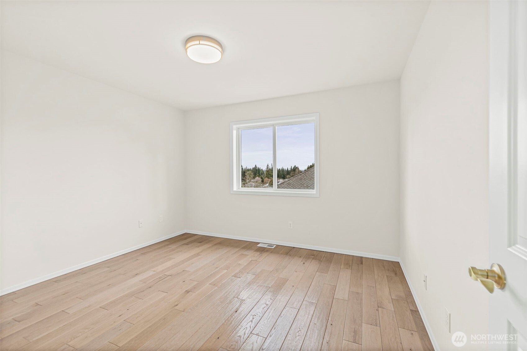 2018 242nd Street Southeast Bothell, WA 98021 - Photo 20 of 26 an empty room with wooden floor and windows