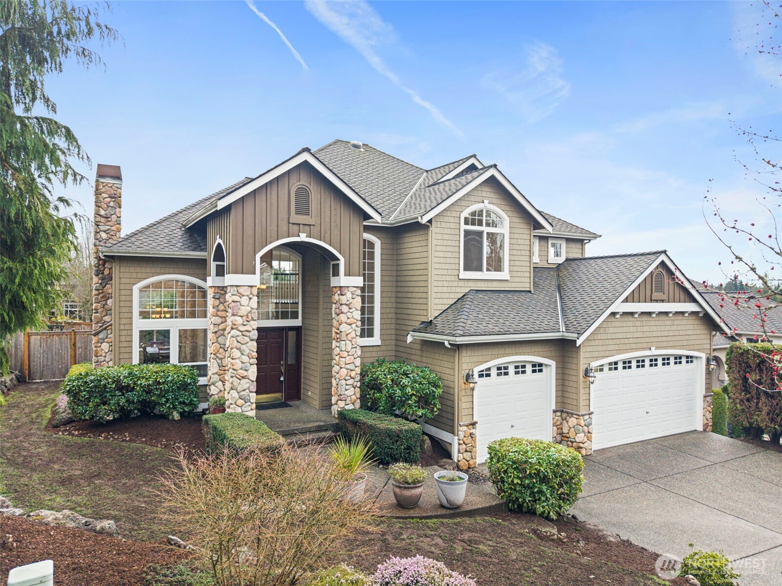 2018 242nd Street Southeast Bothell, WA 98021 - Photo 2 of 26 a front view of a house with a yard and garage