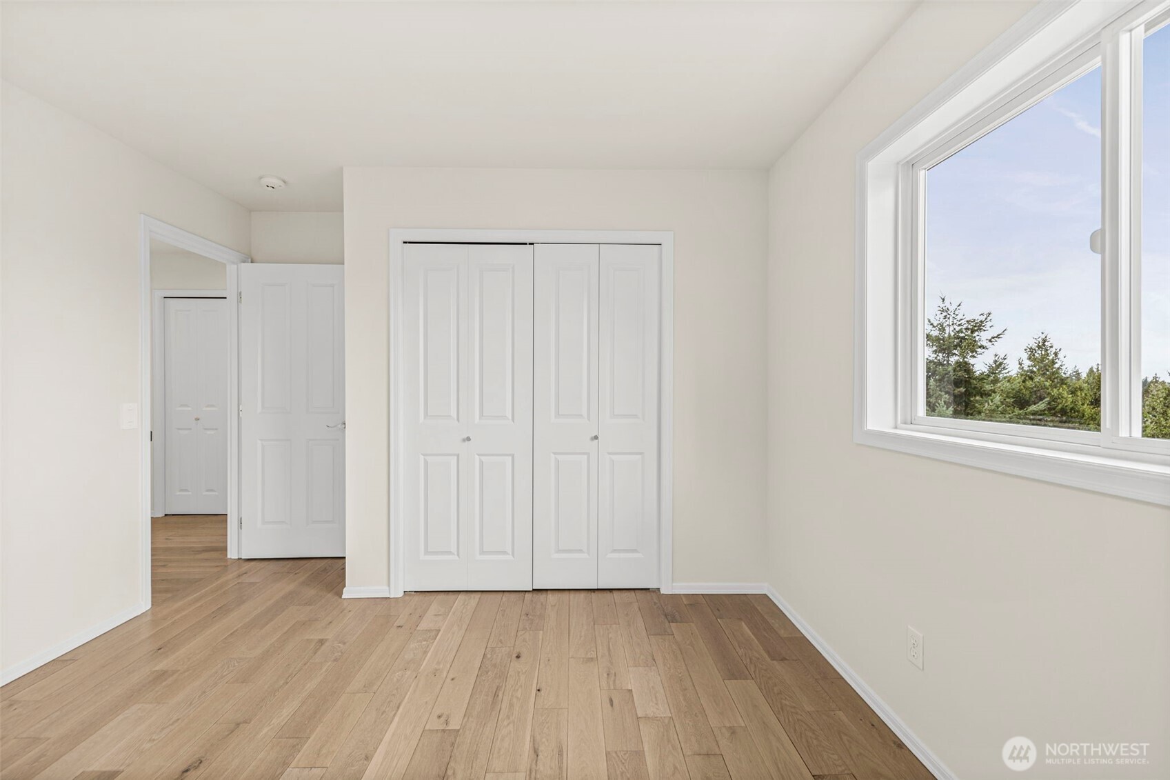 2018 242nd Street Southeast Bothell, WA 98021 - Photo 21 of 26 a view of an empty room with wooden floor and a window