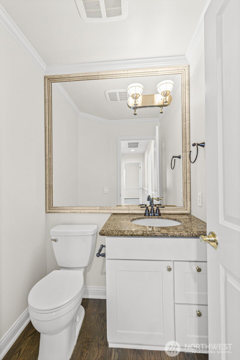 2018 242nd Street Southeast Bothell, WA 98021 - Photo 7 of 26 a bathroom with a granite countertop toilet sink and mirror