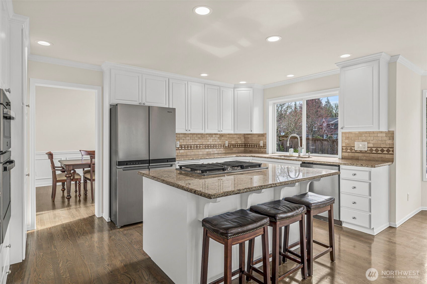 2018 242nd Street Southeast Bothell, WA 98021 - Photo 9 of 26 a kitchen with a stove a refrigerator and a dining table