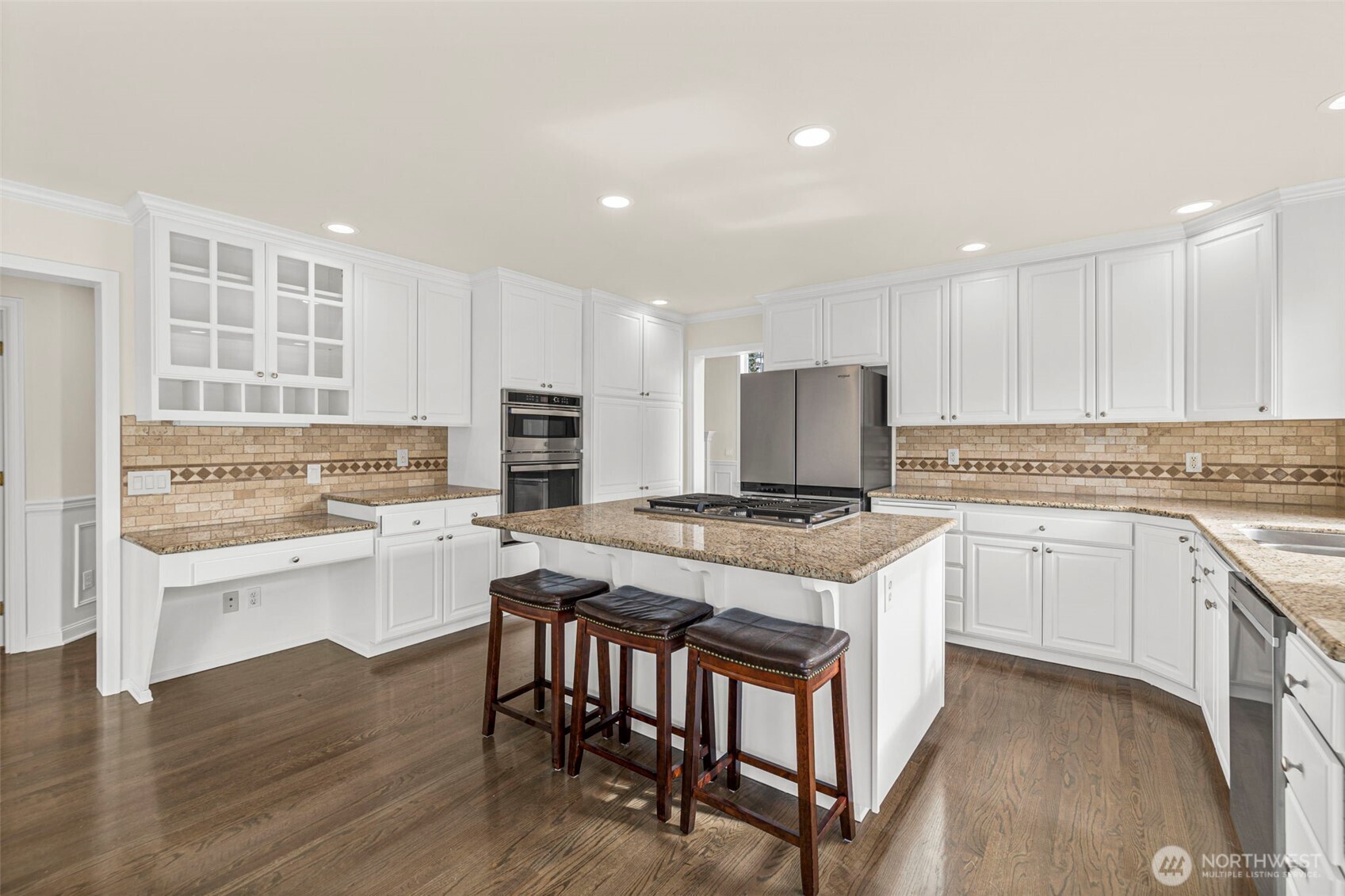 2018 242nd Street Southeast Bothell, WA 98021 - Photo 10 of 26 a kitchen with granite countertop white cabinets and white appliances