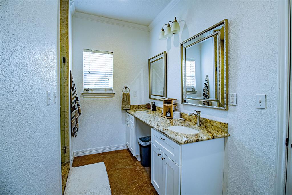 328 Meadow Lane Red Oak, TX 75154 - Photo 16 of 35 Bathroom with a textured wall, healthy amount of natural light, double vanity, crown molding, and a stall shower