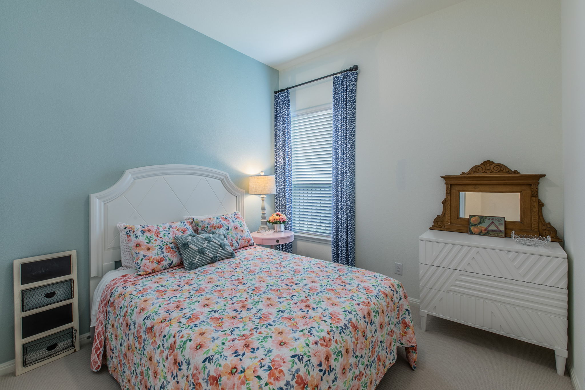 231 Simon Kyle, TX 78640 - Photo 20 of 29 Bedroom featuring light blue accent wall and neutral carpeting