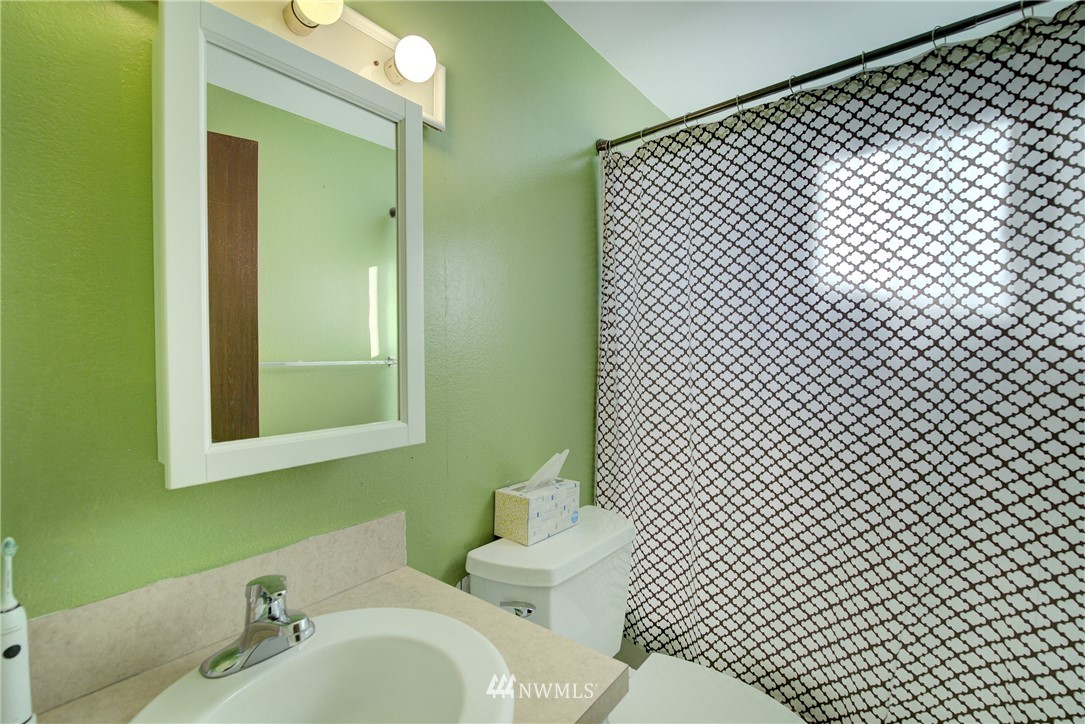 126 Pelly Avenue North, Unit AB Renton, WA 98057 - Photo 12 of 23 a bathroom with a sink and a mirror