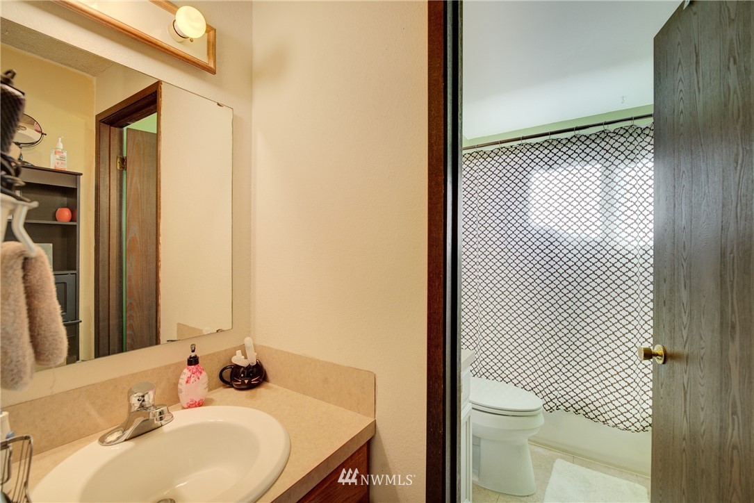 126 Pelly Avenue North, Unit AB Renton, WA 98057 - Photo 13 of 23 a bathroom with a sink toilet and shower
