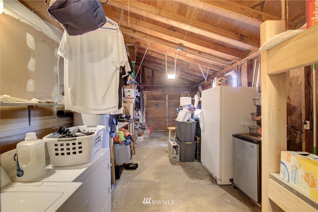 126 Pelly Avenue North, Unit AB Renton, WA 98057 - Photo 14 of 23 a kitchen with stainless steel appliances kitchen island granite countertop a refrigerator and a stove