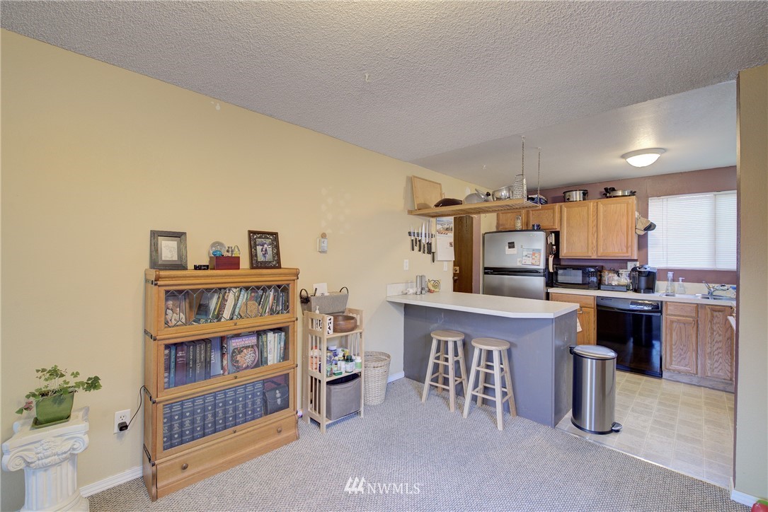 126 Pelly Avenue North, Unit AB Renton, WA 98057 - Photo 4 of 23 a open kitchen with stainless steel appliances granite countertop a sink and a refrigerator