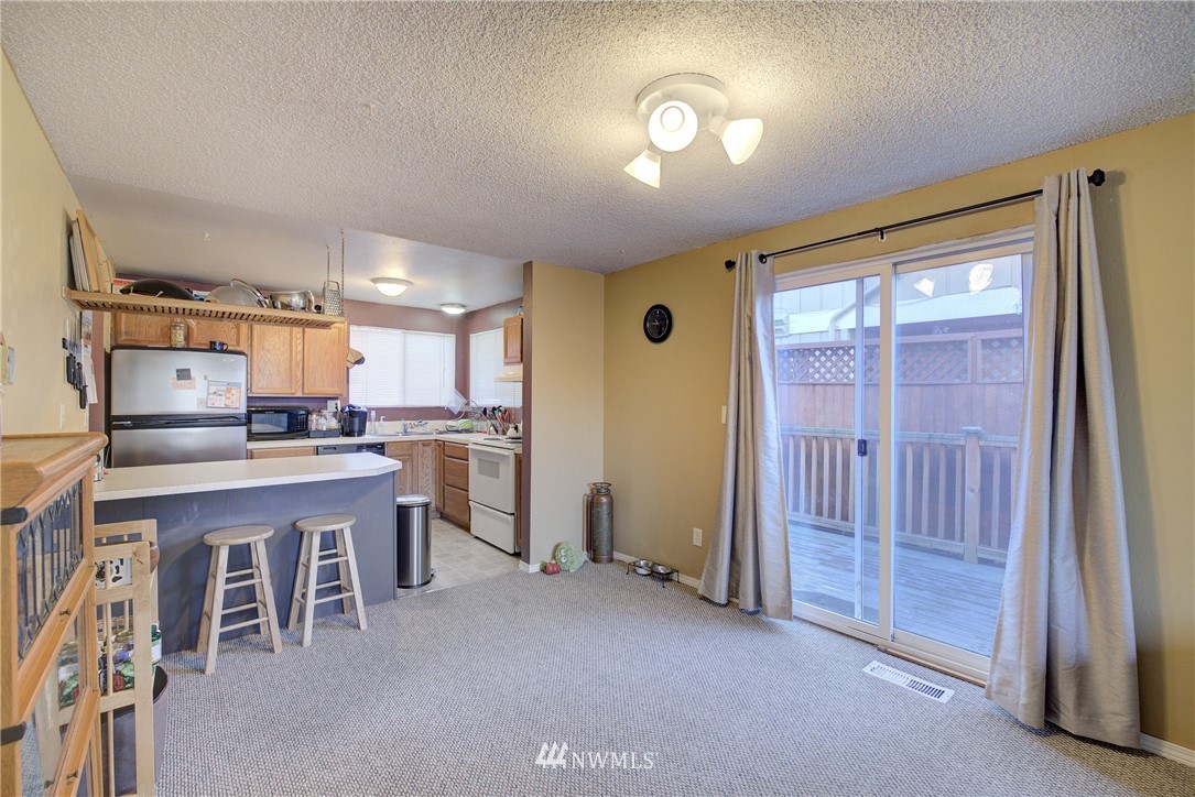 126 Pelly Avenue North, Unit AB Renton, WA 98057 - Photo 5 of 23 a living room with stainless steel appliances granite countertop furniture and a kitchen view