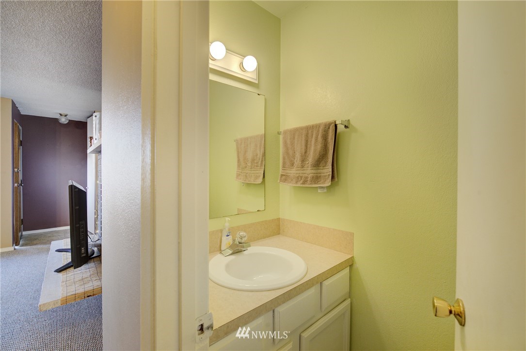 126 Pelly Avenue North, Unit AB Renton, WA 98057 - Photo 8 of 23 a bathroom with a sink and a mirror