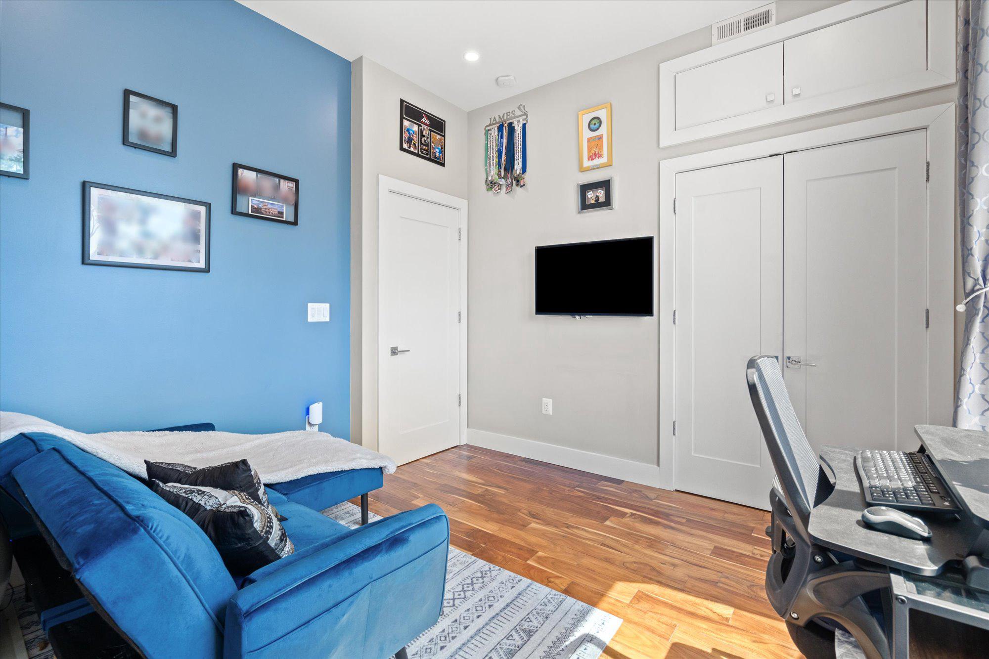 1337 K Street Southeast, Unit PH2 Washington, DC 20003 - Photo 18 of 22 Charming guest room with vibrant blue accents.