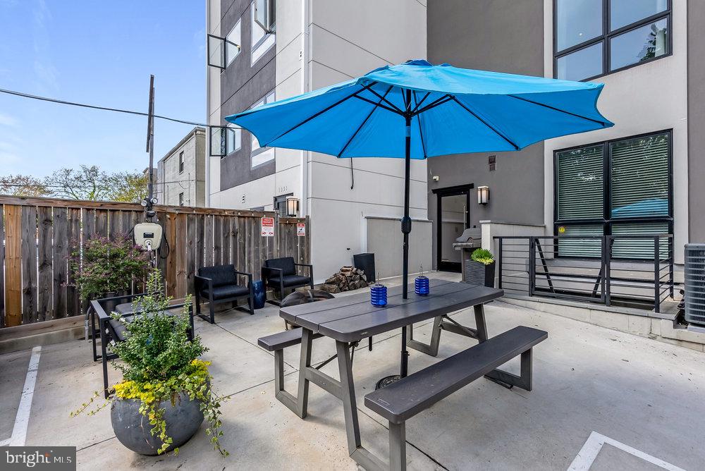 1337 K Street Southeast, Unit PH2 Washington, DC 20003 - Photo 21 of 22 Charming outdoor space with vibrant umbrella.