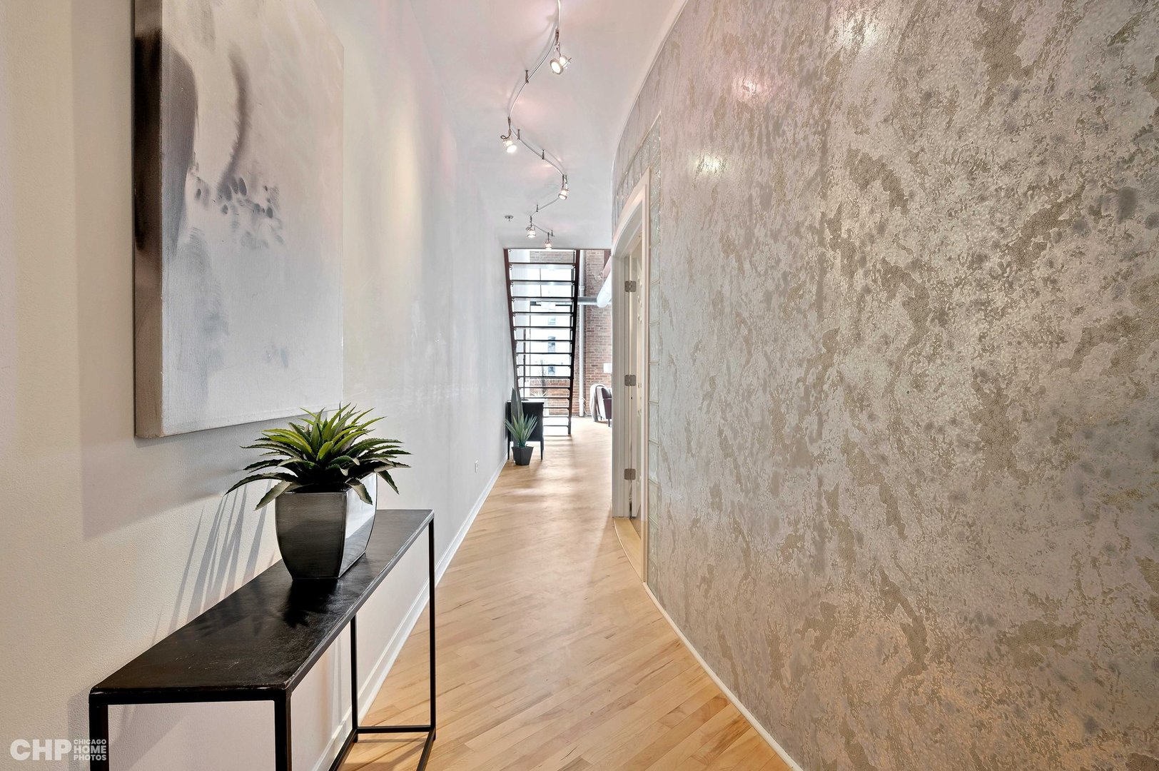 203 South Sangamon Street, Unit 206 Chicago, IL 60607 - Photo 16 of 20 a view of a hallway with potted plants
