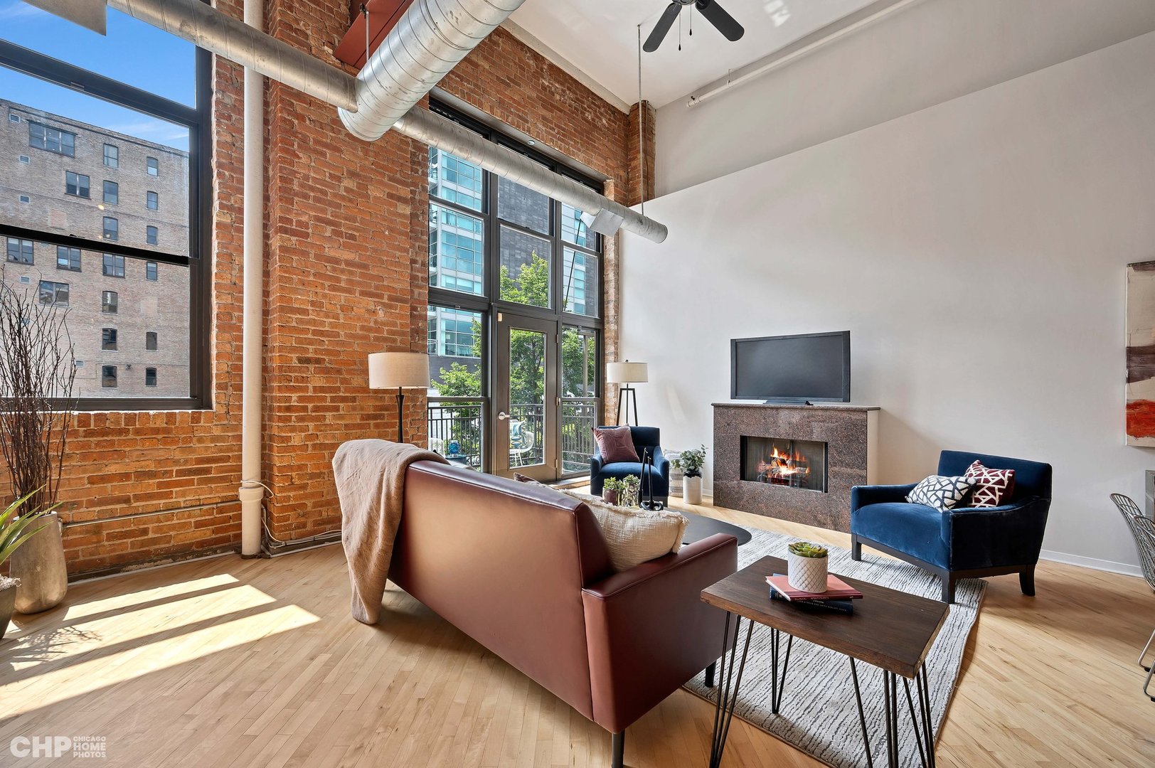 203 South Sangamon Street, Unit 206 Chicago, IL 60607 - Photo 4 of 20 a living room with furniture a flat screen tv and a fireplace