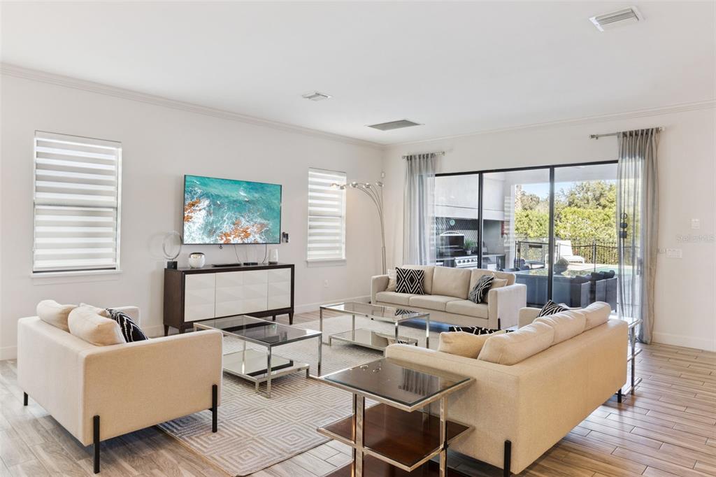 7423 Sparkling Court Reunion, FL 34747 - Photo 15 of 62 a living room with furniture and a large window