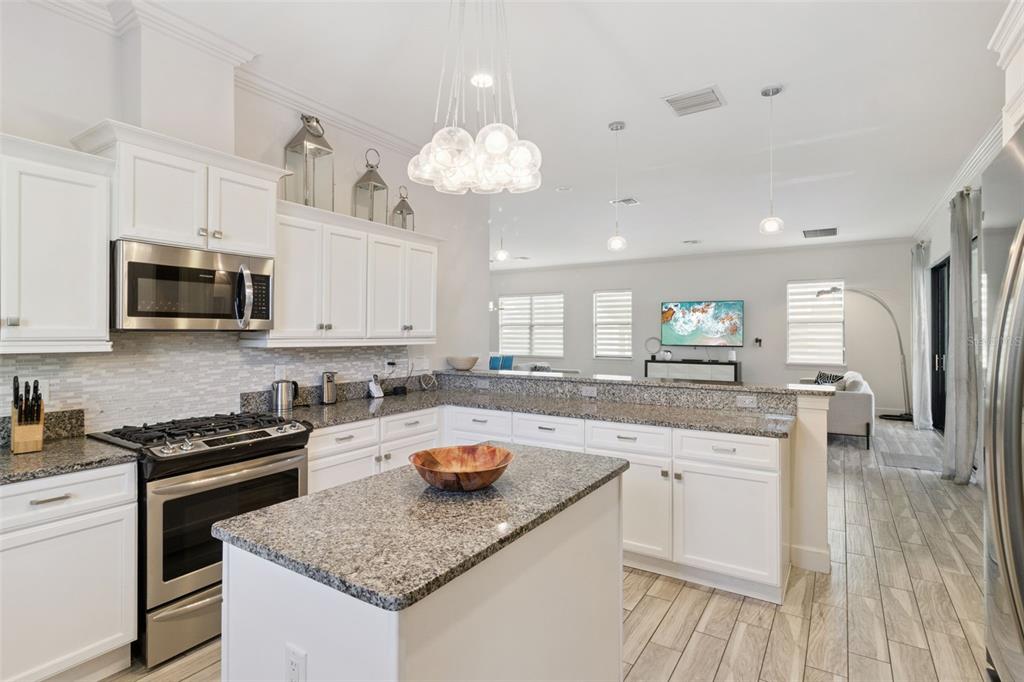7423 Sparkling Court Reunion, FL 34747 - Photo 18 of 62 a kitchen with a sink a stove and cabinets