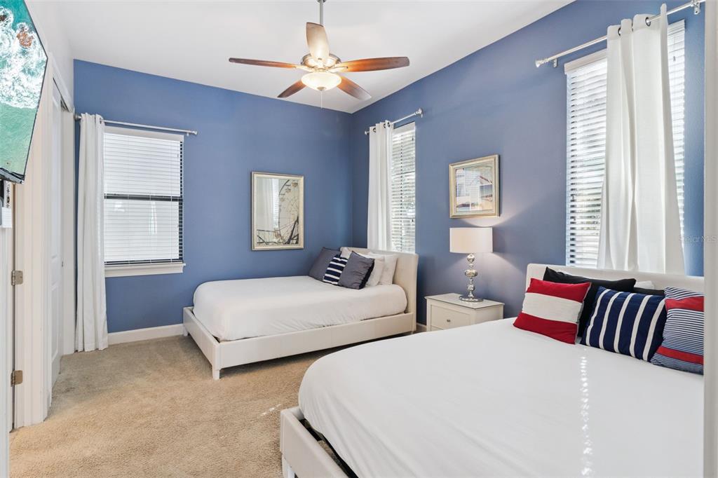 7423 Sparkling Court Reunion, FL 34747 - Photo 22 of 62 a bedroom with two beds and a window