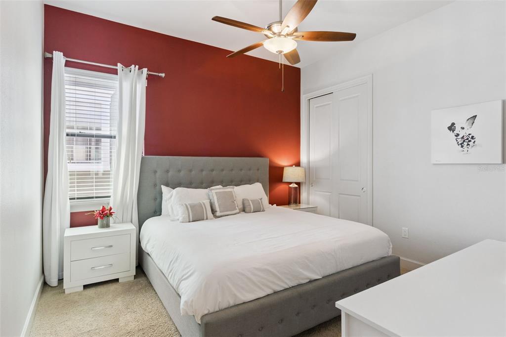 7423 Sparkling Court Reunion, FL 34747 - Photo 24 of 62 a bedroom with a bed and a chandelier