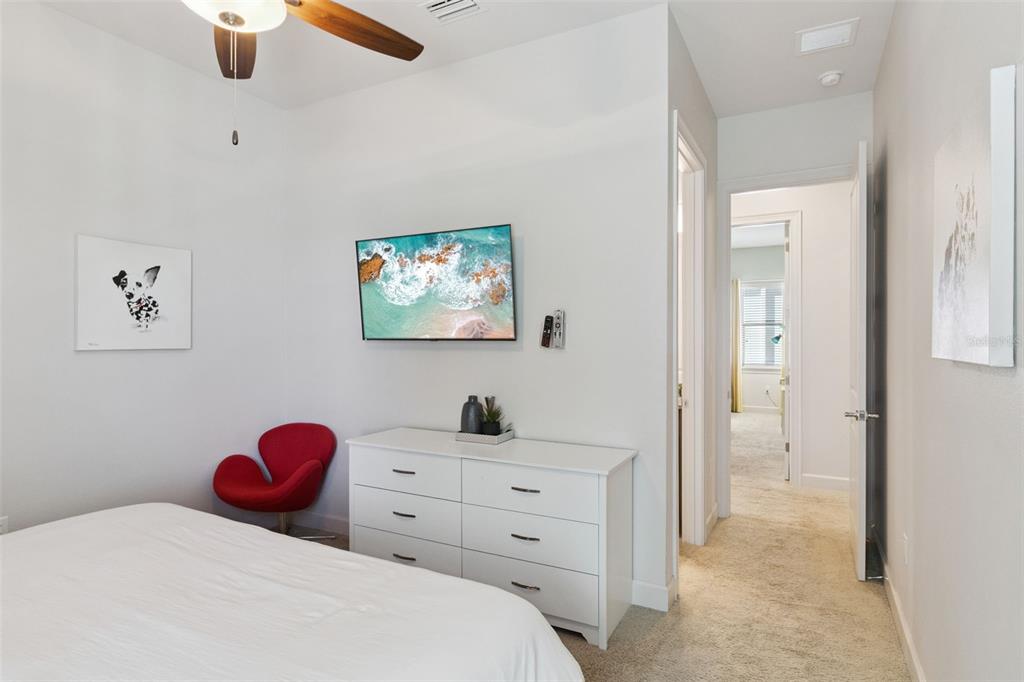 7423 Sparkling Court Reunion, FL 34747 - Photo 25 of 62 a bedroom with a bed and a chandelier