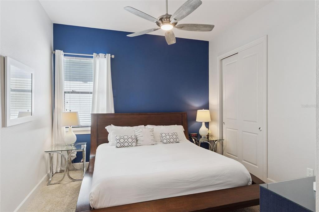 7423 Sparkling Court Reunion, FL 34747 - Photo 27 of 62 a bedroom with a bed and a chandelier