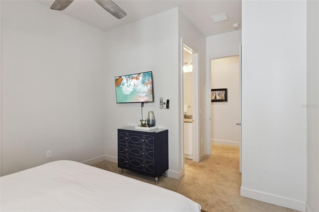 7423 Sparkling Court Reunion, FL 34747 - Photo 28 of 62 a bedroom with a bed and a flat screen tv