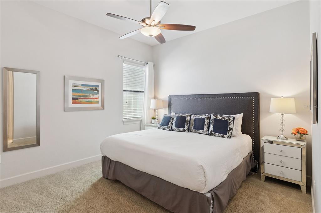 7423 Sparkling Court Reunion, FL 34747 - Photo 29 of 62 a bedroom with a bed and a chandelier