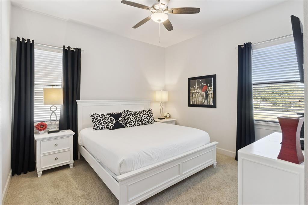 7423 Sparkling Court Reunion, FL 34747 - Photo 31 of 62 a bedroom with a bed and a flat screen tv