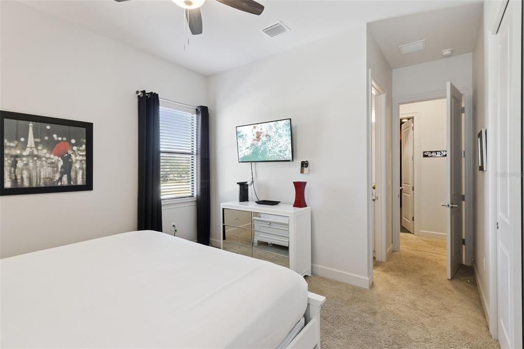 7423 Sparkling Court Reunion, FL 34747 - Photo 32 of 62 a bedroom with a bed and a chandelier