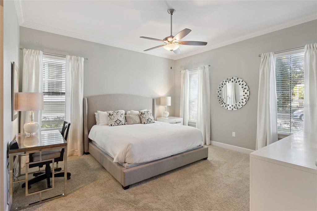 7423 Sparkling Court Reunion, FL 34747 - Photo 6 of 62 a bedroom with a large bed and a chandelier