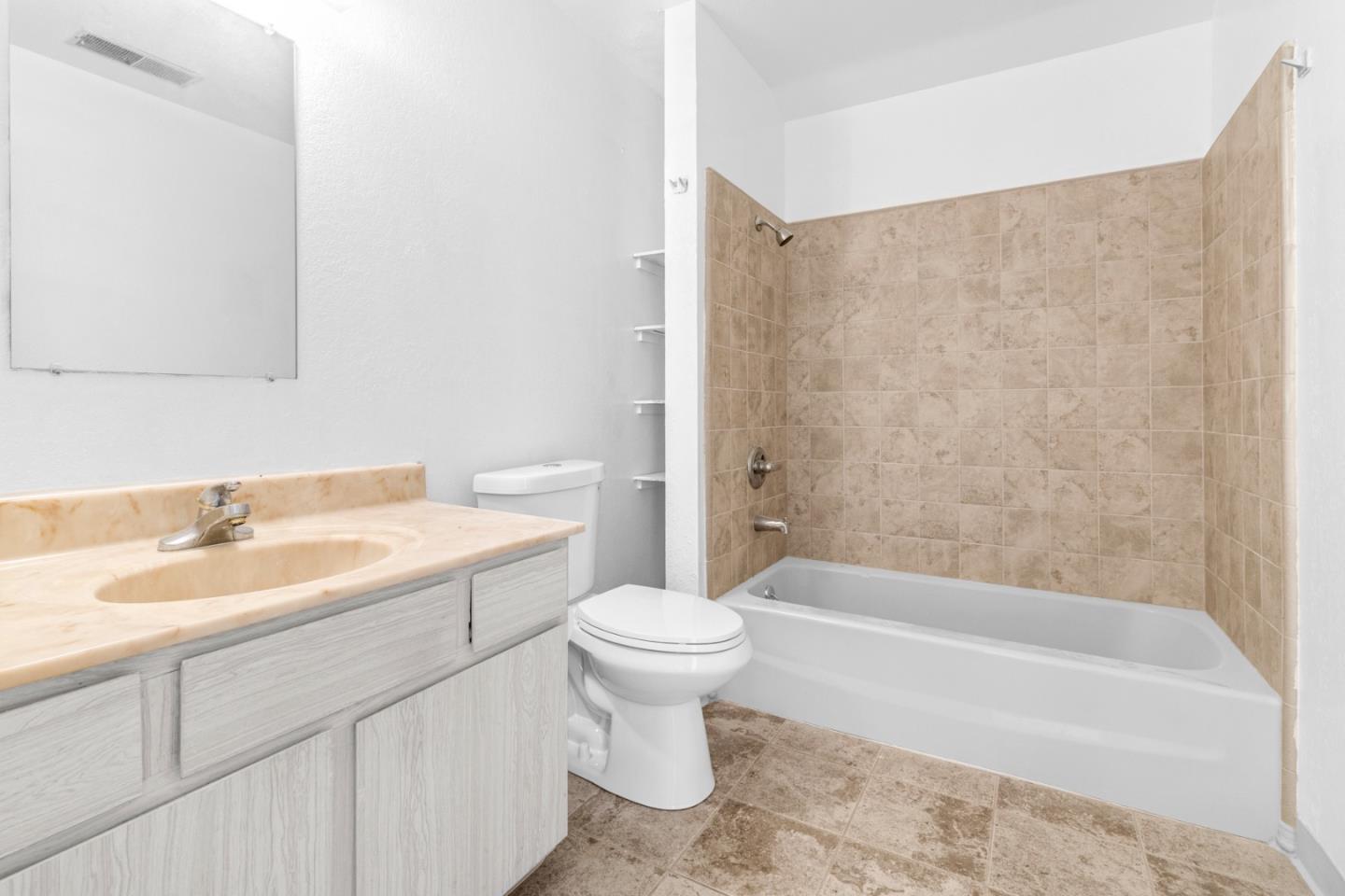 967 Hilby Avenue, Unit C Seaside, CA 93955 - Photo 13 of 24 a bathroom with a sink a toilet and a bathtub