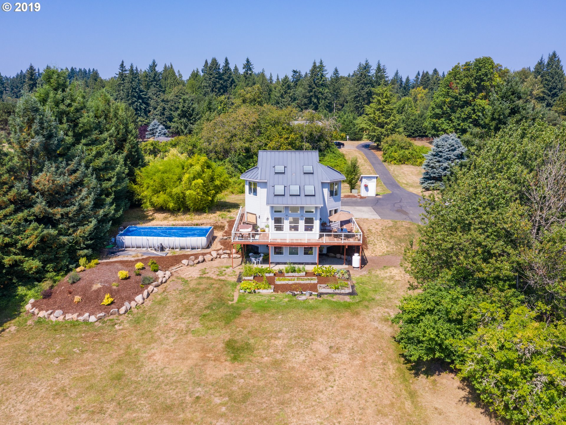 417 Northeast 299th Street Ridgefield, WA 98642 - Photo 12 of 32 a swimming pool with trees in the background