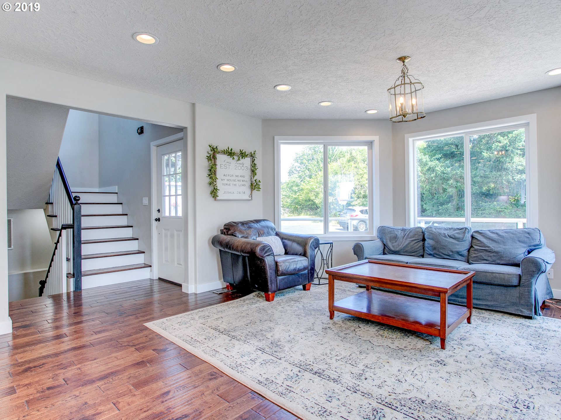 417 Northeast 299th Street Ridgefield, WA 98642 - Photo 14 of 32 a living room with furniture and a wooden floor