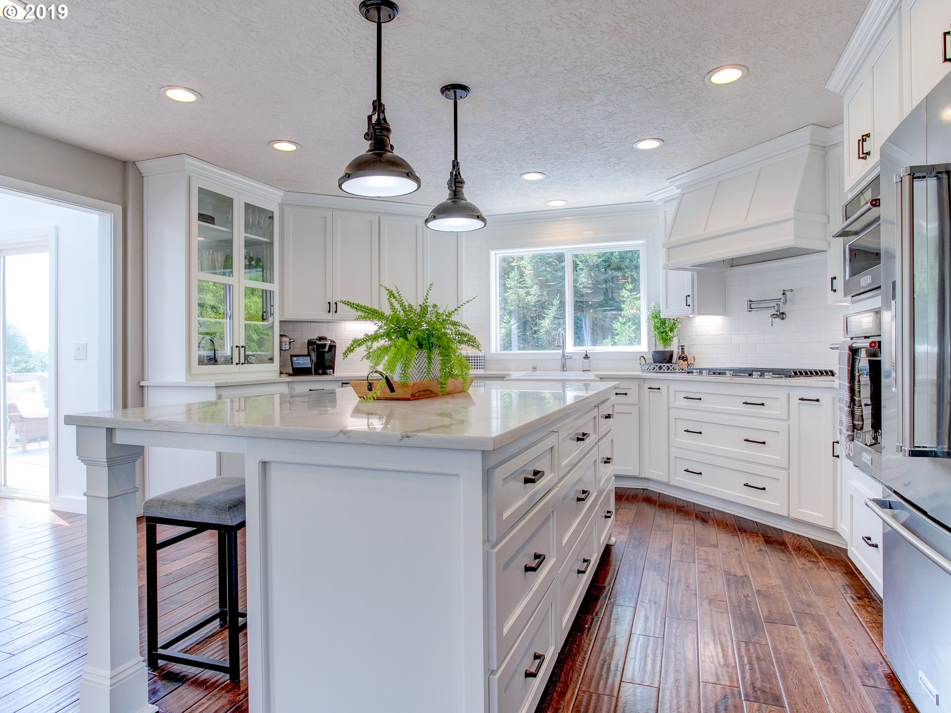 417 Northeast 299th Street Ridgefield, WA 98642 - Photo 19 of 32 a kitchen with granite countertop a stove a sink and a chandelier
