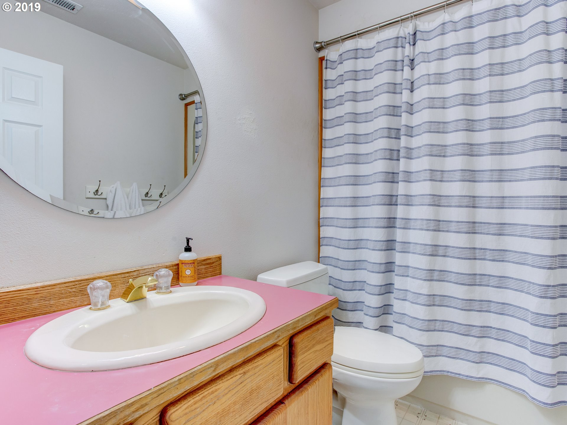 417 Northeast 299th Street Ridgefield, WA 98642 - Photo 27 of 32 a bathroom with a sink a toilet and mirror