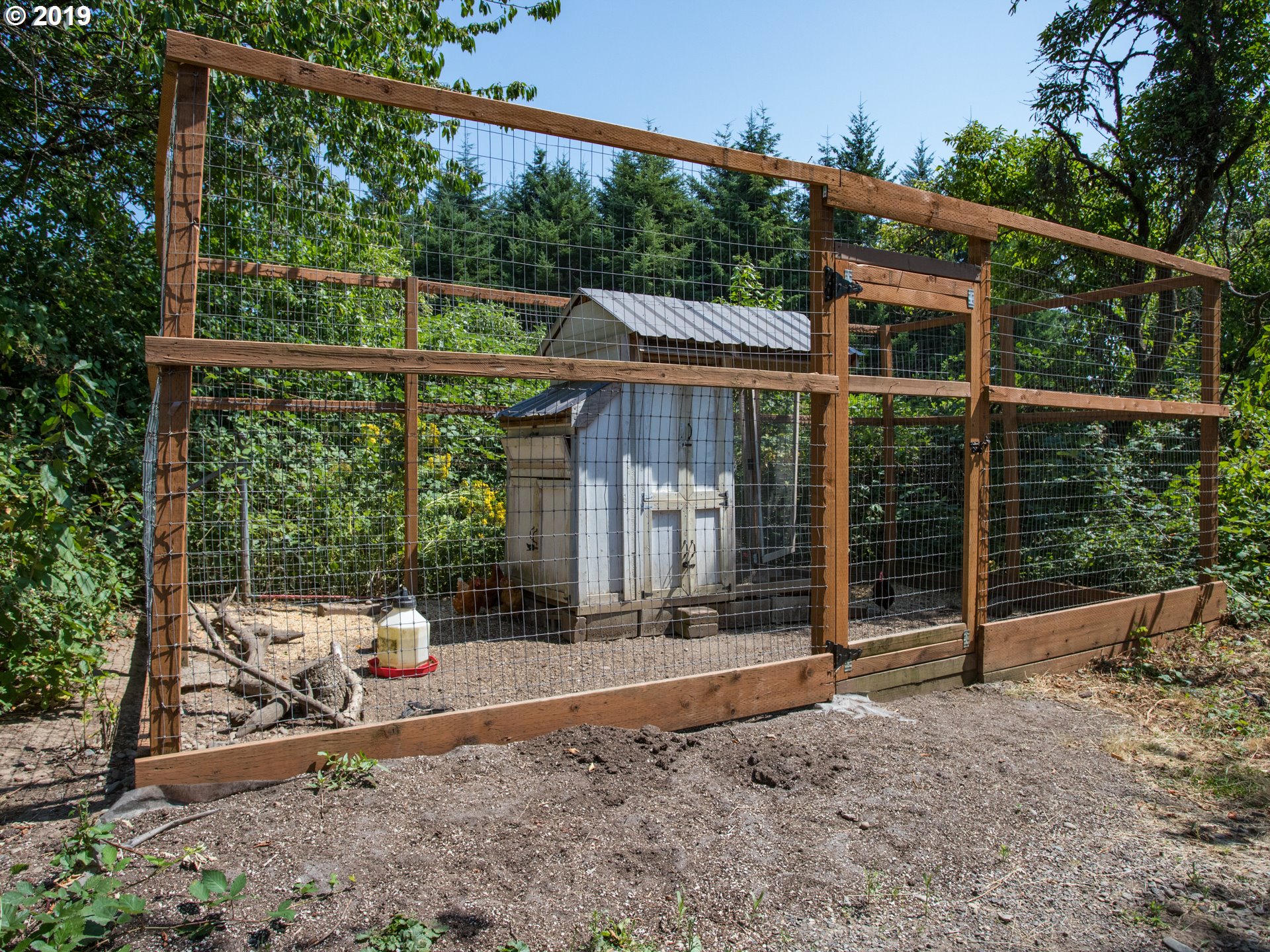 417 Northeast 299th Street Ridgefield, WA 98642 - Photo 8 of 32 a backyard of a house with a swing chair and table