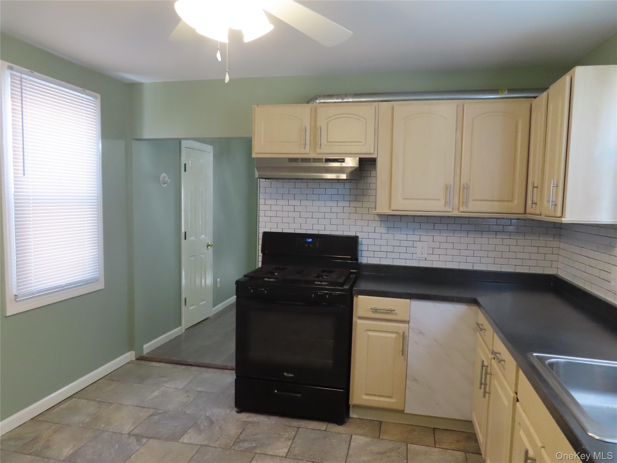 44 Terry Street Patchogue, NY 11772 - Photo 4 of 15 a kitchen with a sink and cabinets